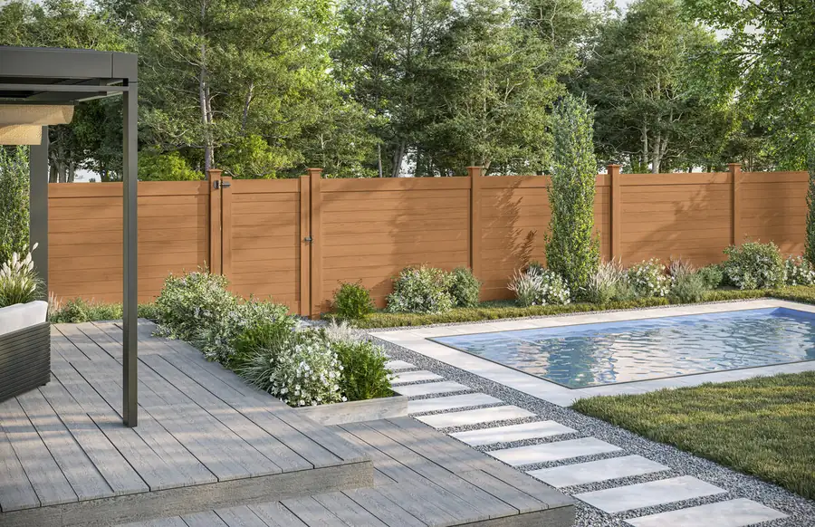 Horizontal-plank vinyl privacy fence in a cypress wood-look finish